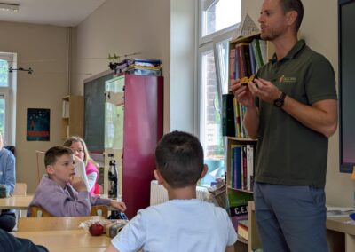 L'animateur montre à la classe un fruit de la passion coupé.